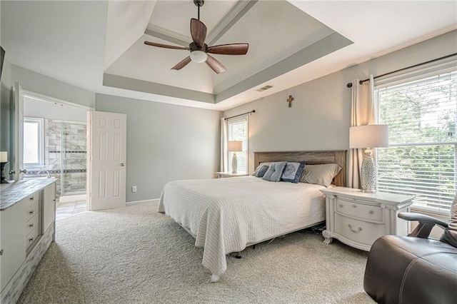 10865 Glenhurst Pass, Duluth, GA 30097 - bedroom with a tray ceiling, light colored carpet, ensuite bathroom, and a ceiling fan