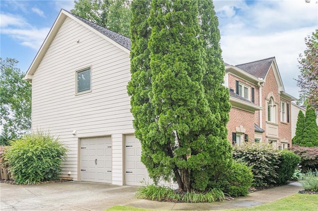 10865 Glenhurst Pass, Duluth, GA 30097 - view of side of home with an attached garage, driveway, and brick siding