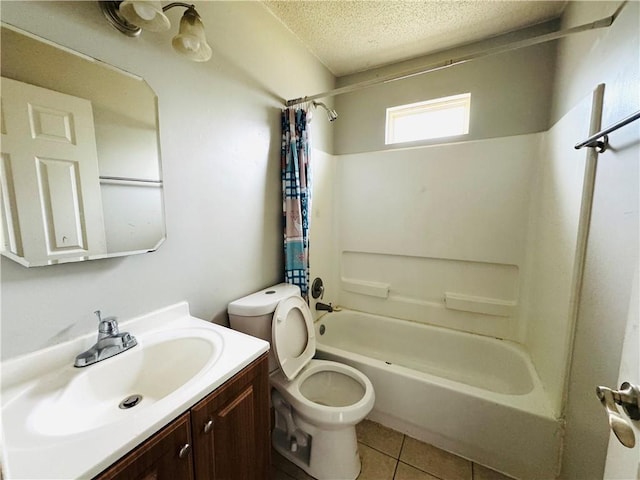 bathroom with vanity, toilet, a textured ceiling, tile patterned floors, and shower / tub combo