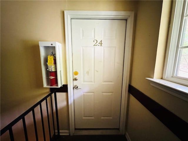 doorway to outside with baseboards