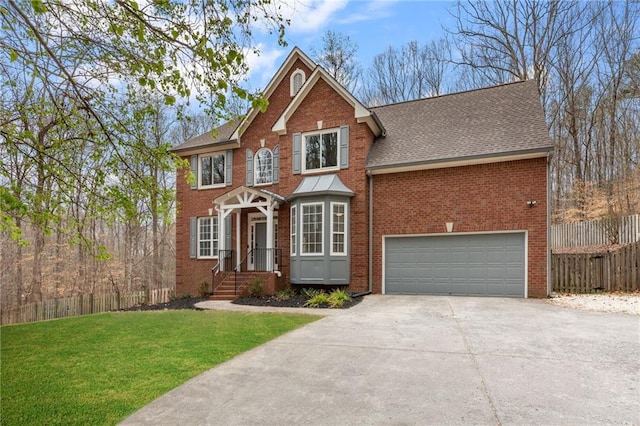 view of front of property featuring brick siding, a front lawn, fence, concrete driveway, and an attached garage