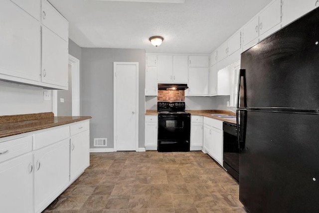 kitchen featuring visible vents, ventilation hood, white cabinets, a sink, and black appliances