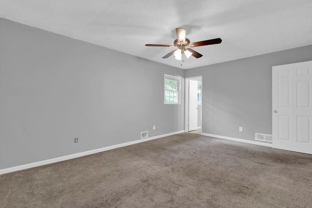 unfurnished room featuring baseboards, ceiling fan, carpet flooring, and visible vents
