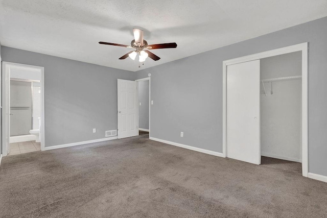 unfurnished bedroom featuring carpet floors, baseboards, visible vents, and a closet