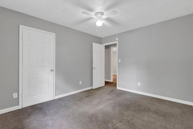 unfurnished bedroom with baseboards, carpet flooring, and ceiling fan