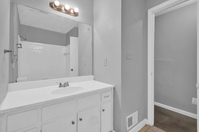 full bath with visible vents, vanity, a shower, baseboards, and tile patterned floors