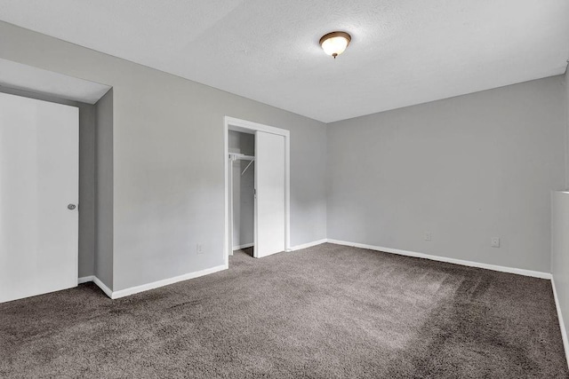 unfurnished bedroom with carpet floors, baseboards, and a closet