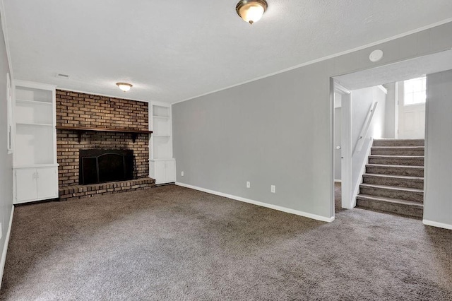 unfurnished living room with crown molding, carpet floors, built in shelves, baseboards, and stairway