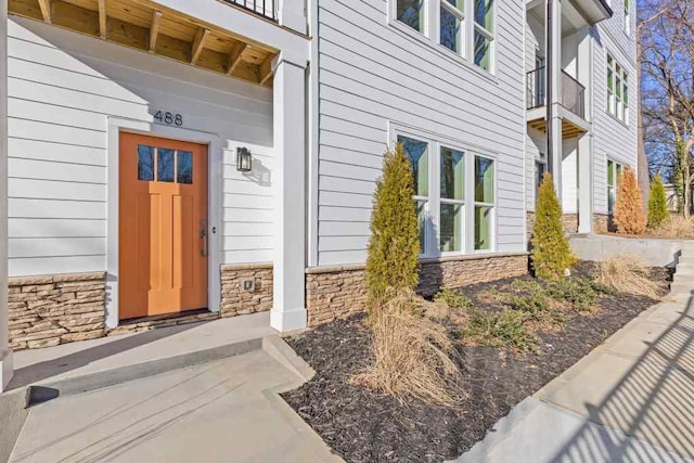 property entrance with stone siding