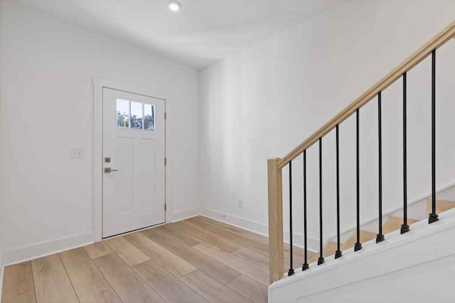 entrance foyer with recessed lighting, light wood-style flooring, and baseboards