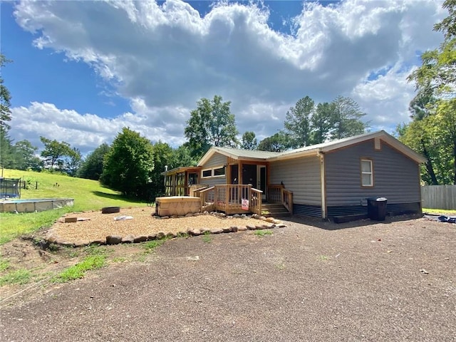 view of front of house with a jacuzzi and a wooden deck