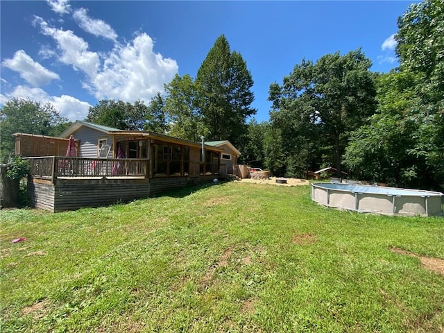 view of yard with a pool side deck