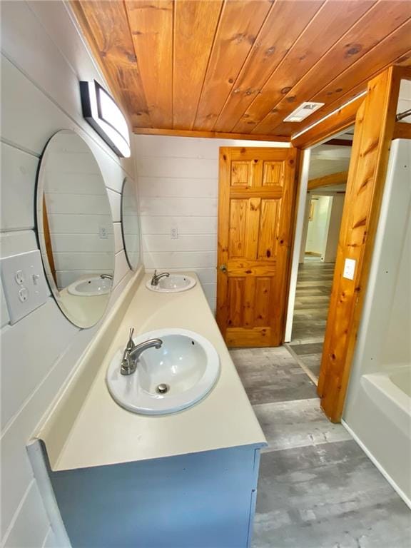 bathroom featuring shower / bathing tub combination, wooden ceiling, hardwood / wood-style flooring, and double sink vanity