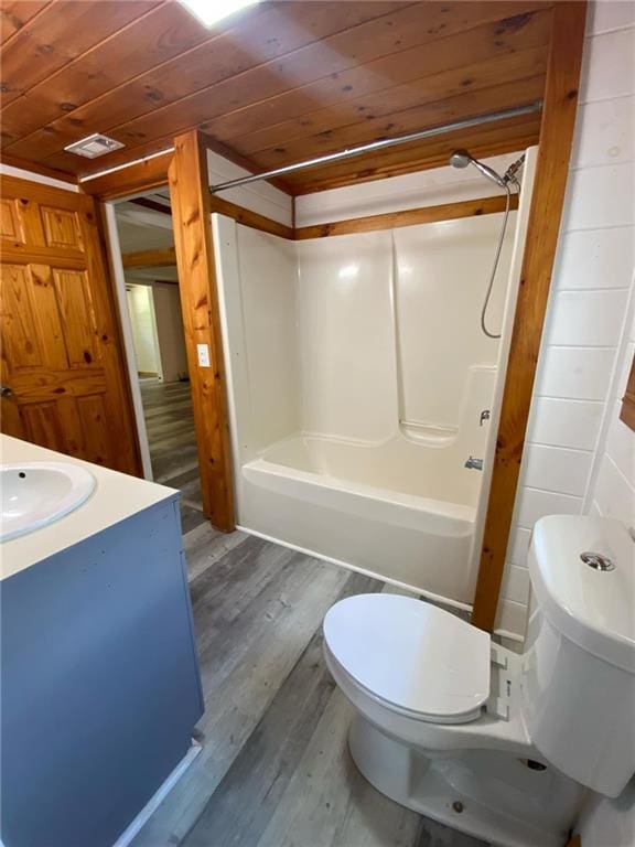 full bathroom featuring washtub / shower combination, toilet, wood ceiling, vanity, and hardwood / wood-style floors