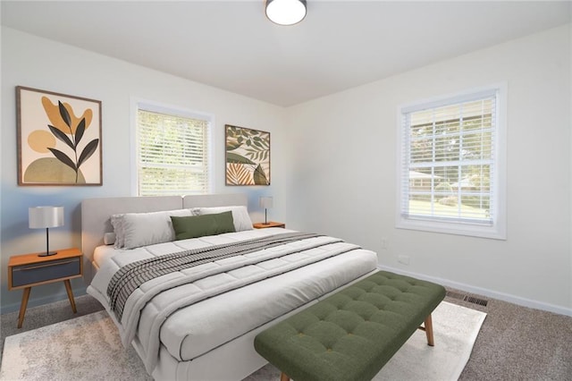 bedroom featuring light carpet