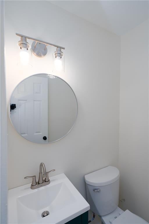 bathroom featuring toilet and vanity