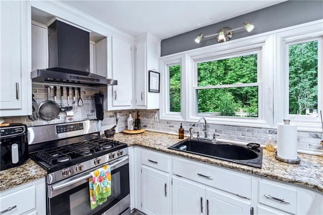 21 Basin Ct, Jasper, GA 30143 - kitchen with gas range, wall chimney range hood, decorative backsplash, and white cabinets
