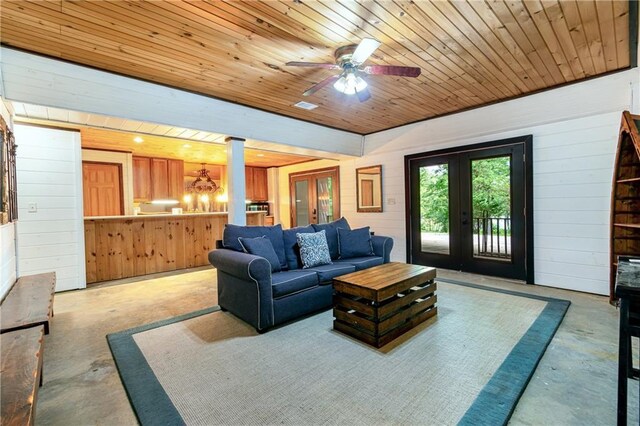 21 Basin Ct, Jasper, GA 30143 - living area with ceiling fan, wood walls, finished concrete floors, wooden ceiling, and decorative columns