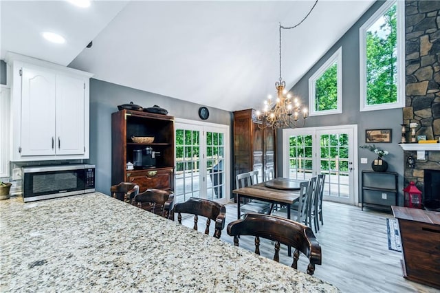 21 Basin Ct, Jasper, GA 30143 - dining area with a chandelier, high vaulted ceiling, french doors, light wood finished floors, and plenty of natural light