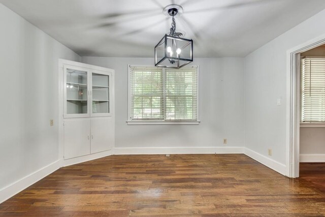 unfurnished dining area with dark hardwood / wood-style flooring