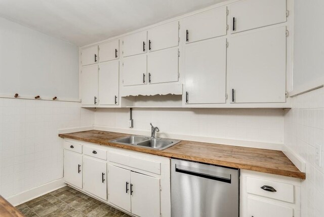 kitchen with white cabinets, dishwasher, sink, and wooden counters