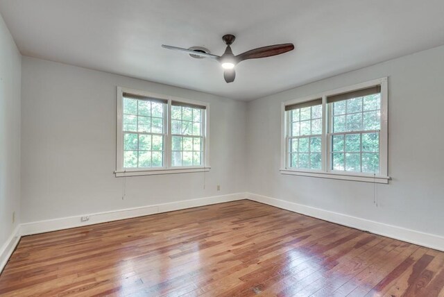 empty room with ceiling fan and light hardwood / wood-style floors