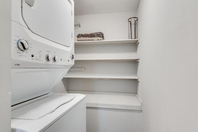 clothes washing area with stacked washer / drying machine