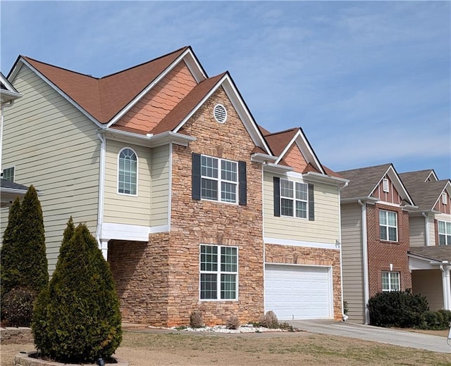 view of front of home with stone siding, concrete driveway, and an attached garage