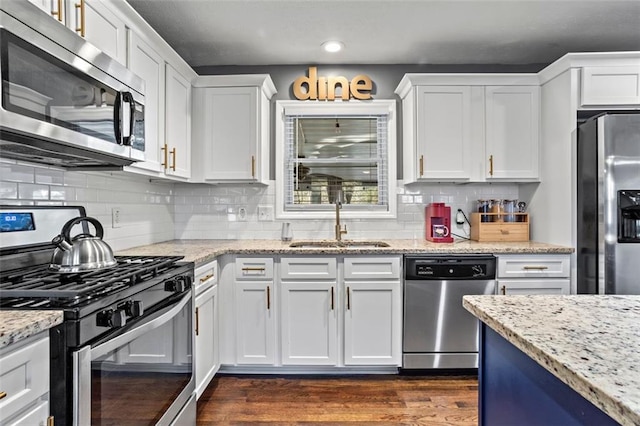 kitchen featuring a sink, dark wood-style floors, white cabinetry, and stainless steel appliances