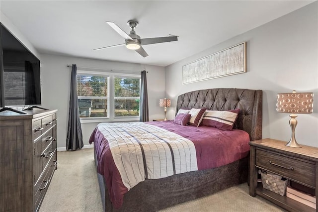 bedroom with a ceiling fan, light colored carpet, and baseboards