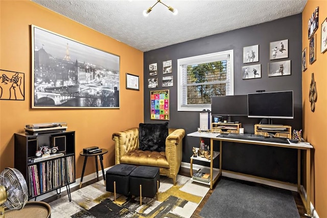 home office with baseboards and a textured ceiling