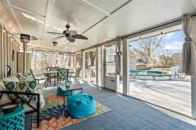 sunroom with a ceiling fan