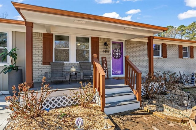 view of front of house with brick siding and covered porch