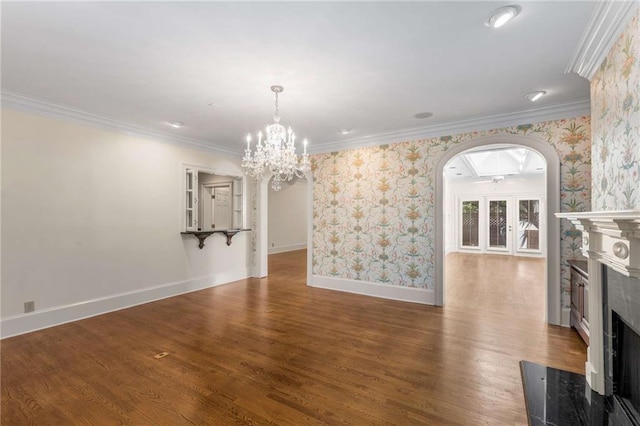 unfurnished dining area with ornamental molding, french doors, dark hardwood / wood-style floors, and an inviting chandelier