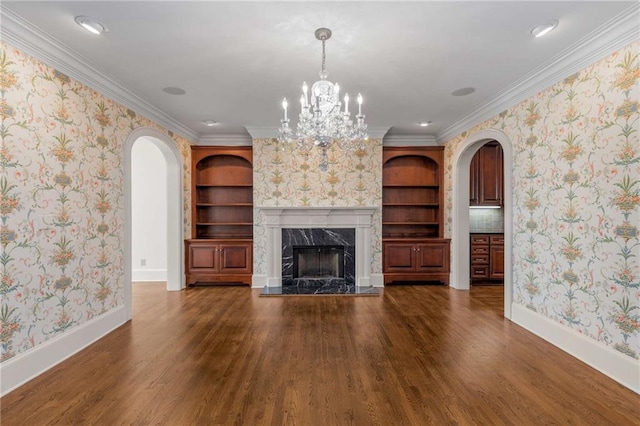 unfurnished living room featuring built in features, dark hardwood / wood-style flooring, and a high end fireplace