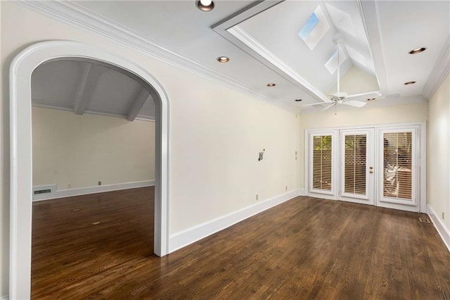 spare room featuring lofted ceiling with beams, ceiling fan, dark hardwood / wood-style floors, crown molding, and french doors