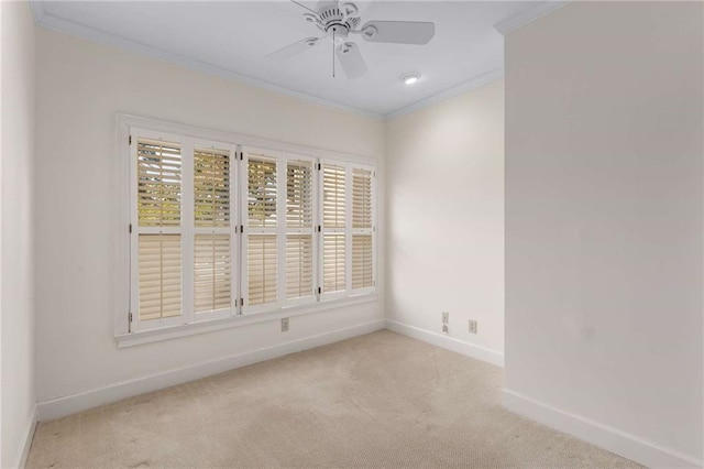 unfurnished room with ornamental molding, light carpet, and ceiling fan