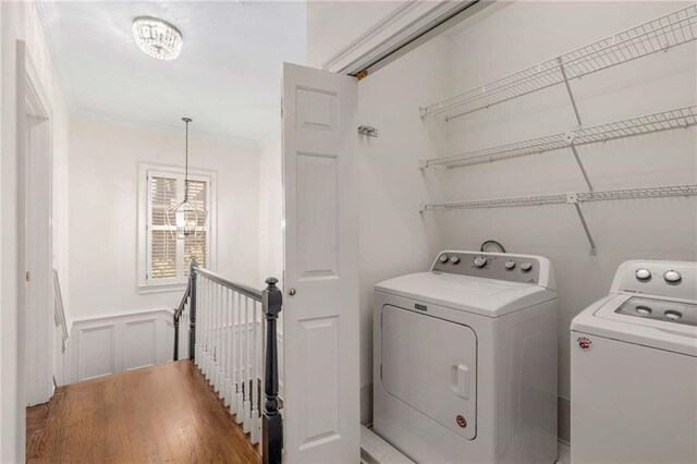 washroom with hardwood / wood-style floors and washer and dryer