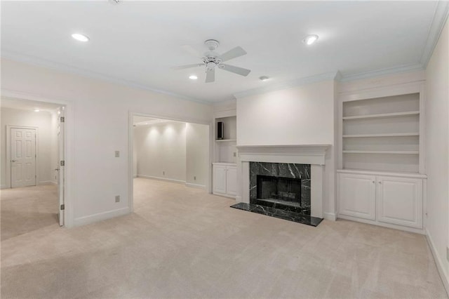 unfurnished living room featuring a fireplace, light carpet, and ceiling fan