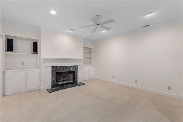 unfurnished living room with a fireplace, light carpet, and crown molding