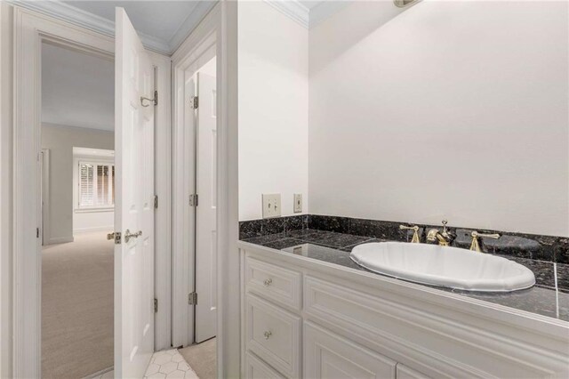 bathroom with ornamental molding and vanity