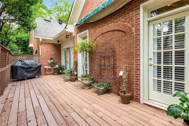 wooden terrace with a grill