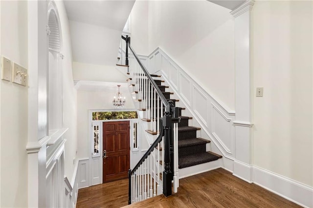 interior space featuring dark wood-type flooring and an inviting chandelier