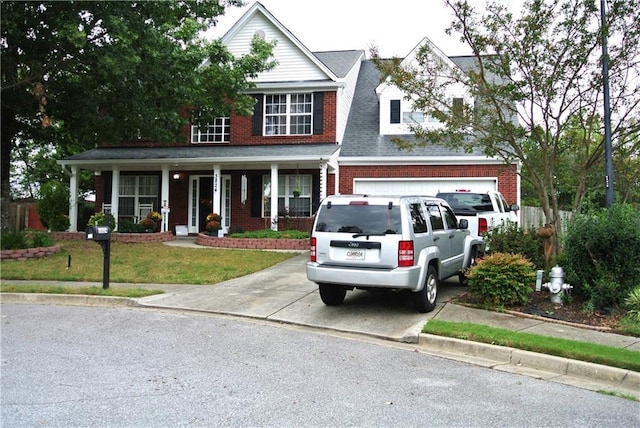 3824 Smith Creek Ct, Buford, GA 30519 - view of front of house featuring covered porch, driveway, brick siding, and a front lawn