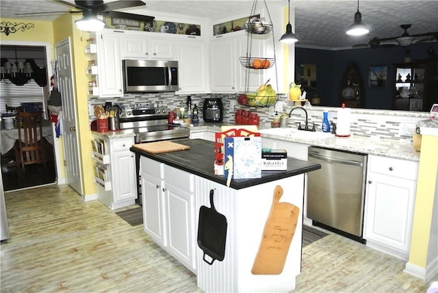 3824 Smith Creek Ct, Buford, GA 30519 - kitchen featuring appliances with stainless steel finishes, backsplash, a ceiling fan, and white cabinets
