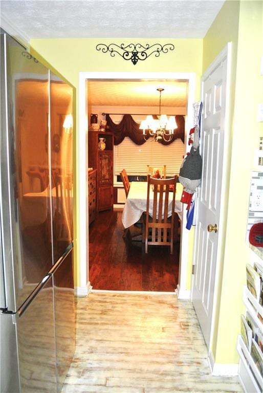 3824 Smith Creek Ct, Buford, GA 30519 - hallway with wood finished floors and a chandelier