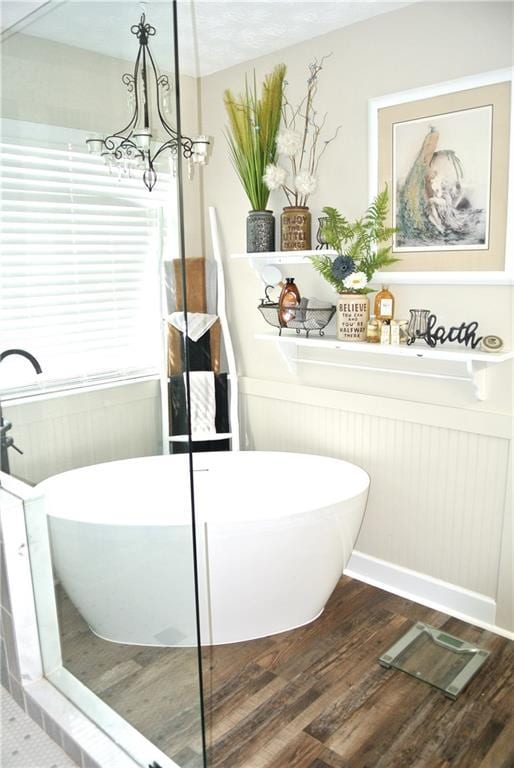 3824 Smith Creek Ct, Buford, GA 30519 - full bathroom featuring a freestanding tub, wood finished floors, and a chandelier