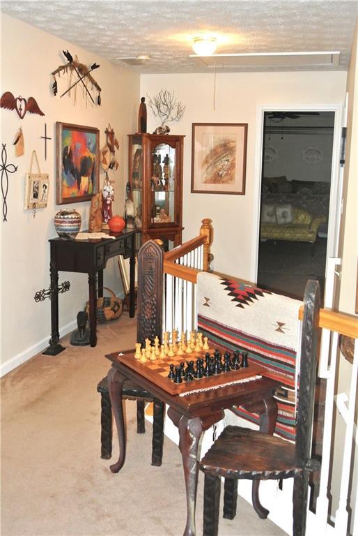3824 Smith Creek Ct, Buford, GA 30519 - sitting room with a textured ceiling and carpet