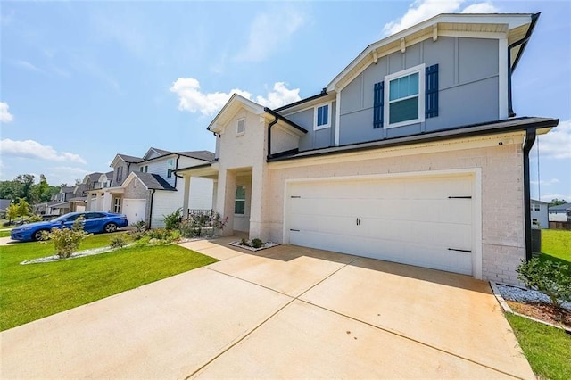 view of front of property featuring an attached garage, board and batten siding, a front yard, a residential view, and driveway