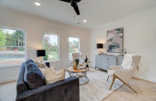 living room featuring baseboards, a wealth of natural light, and wood finished floors